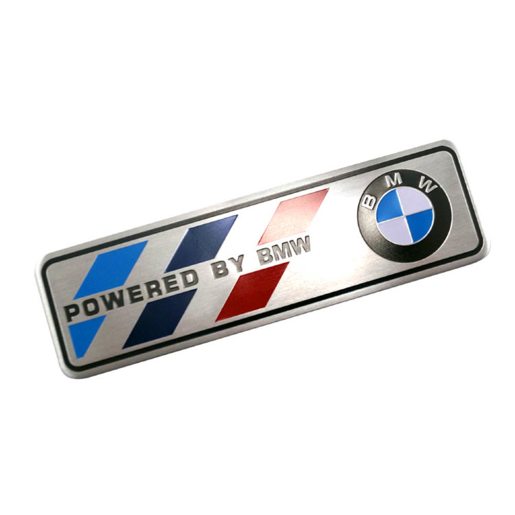 Значок металлический на самоклеящейся основе Powered by BMW 120*26 мм
